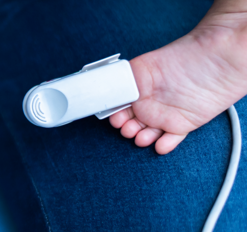 The foot of a baby to which a monitoring device is connected.