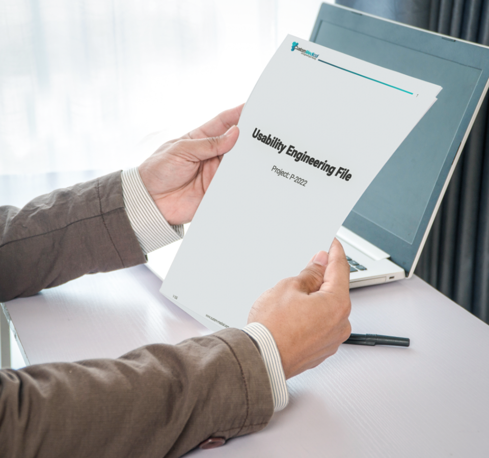 A customer holds a finished usability engineering file in his hands.